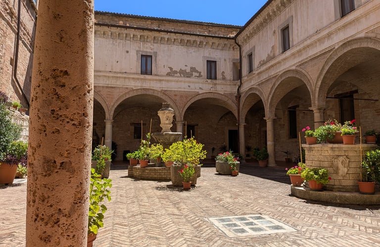 The sunlit cloister at Abbazia San Pietro